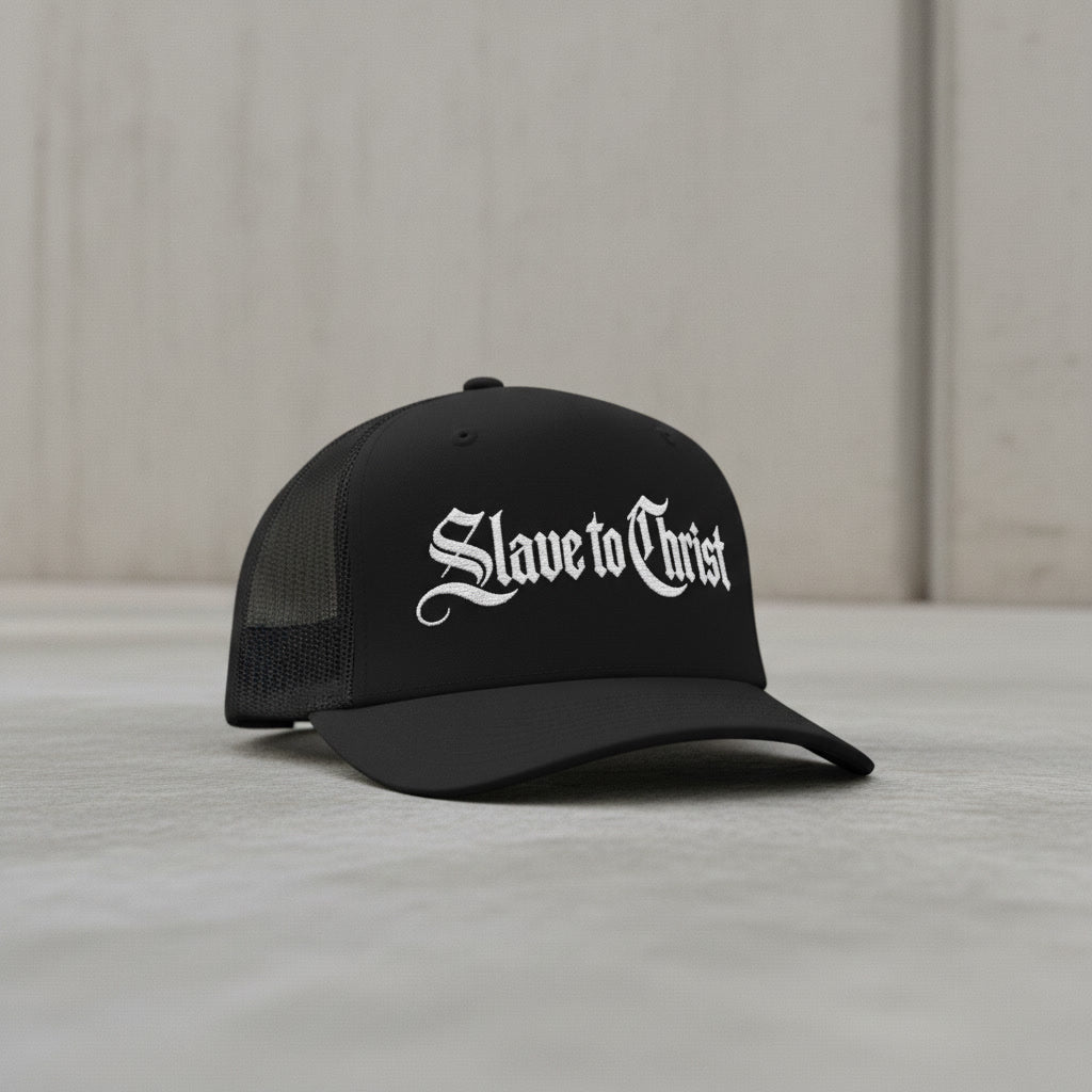 Slave to Christ trucker hat in black with white lettering