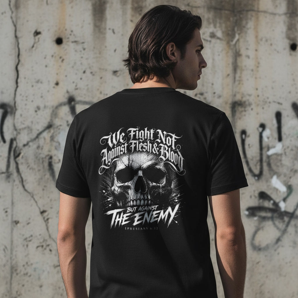 The We Fight Not Against Flesh and Blood design in white on a black t-shirt
